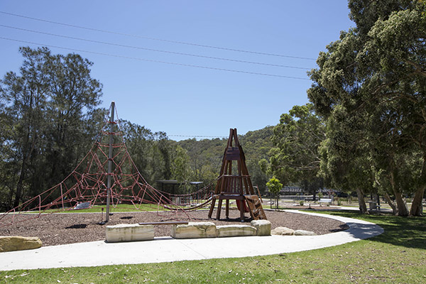 Playground with climbing net and trees