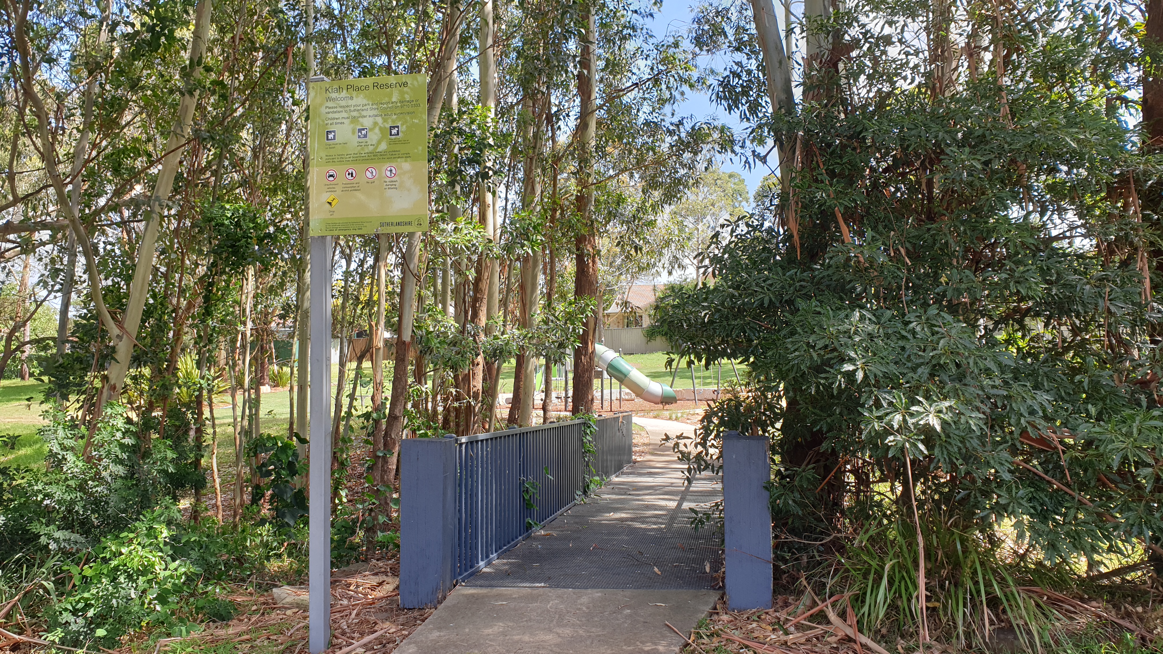 Entrance to footbridge and park signage