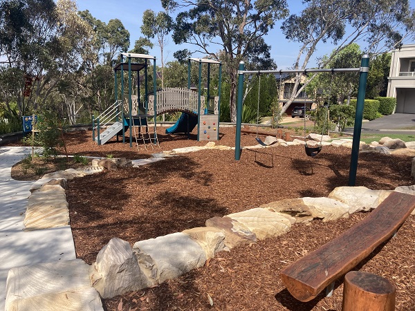 Playground with bark mulch, climbing tower and balance beams