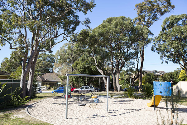 Playground with sand, swings, double rocker and slide