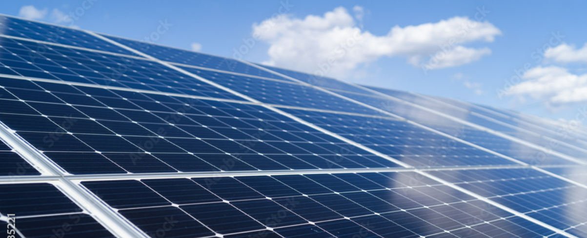 image of a slanted series of solar panels under sunny sky