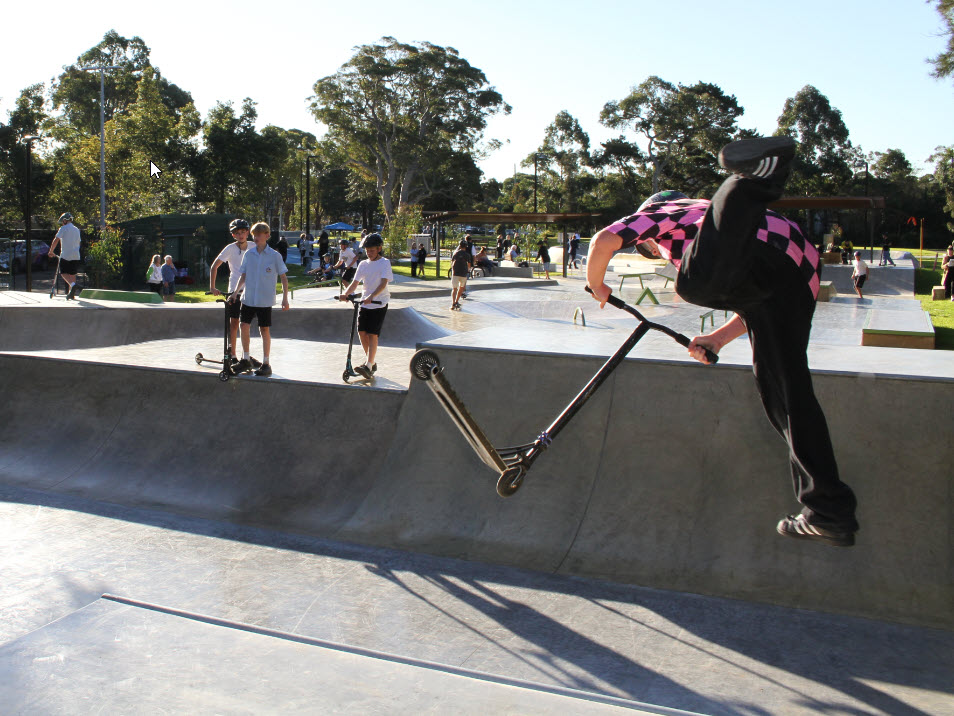 aerial trick on scooter in half pipe