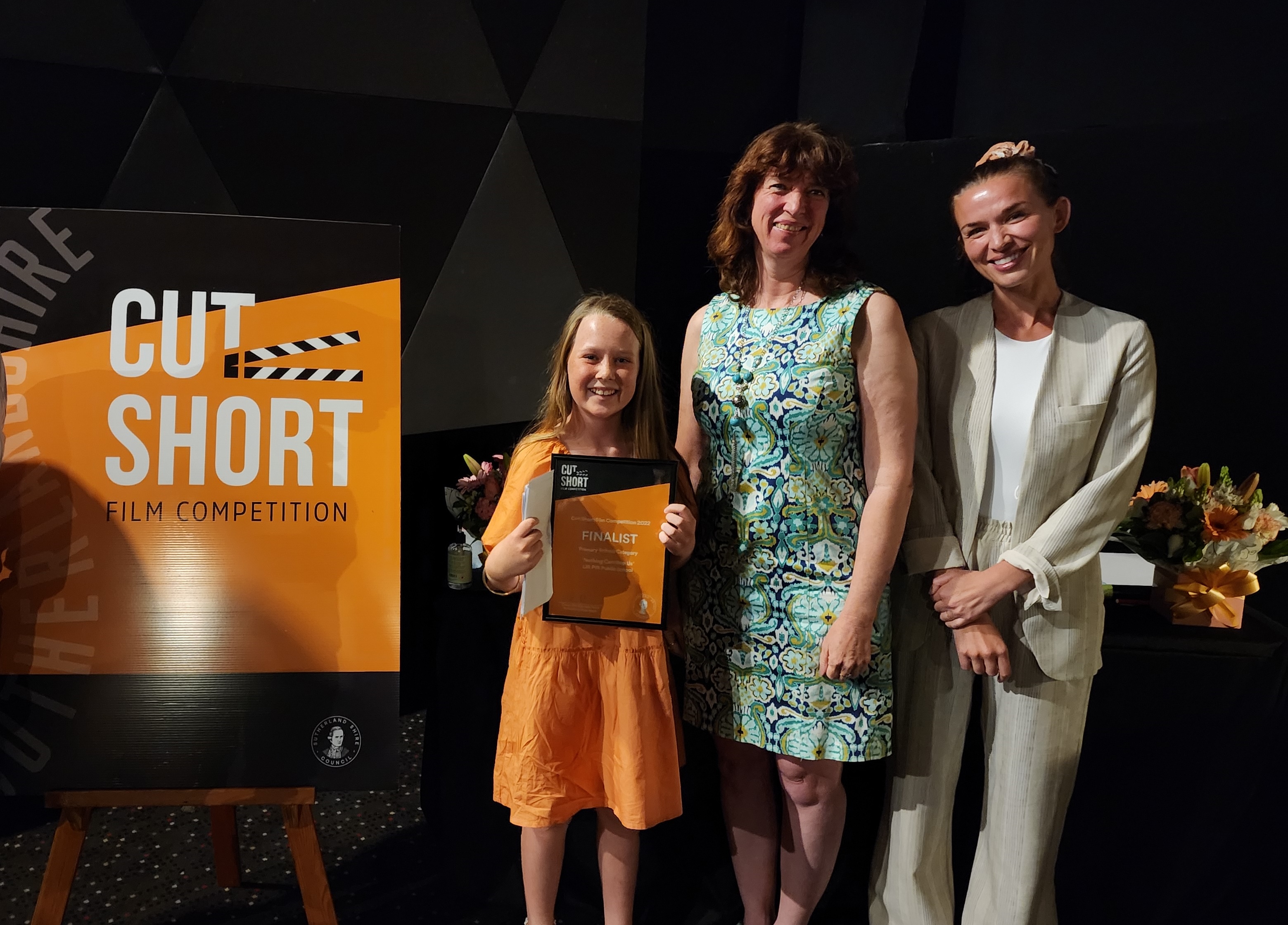 Cut Short Film Competition Junior Finalist holding a certificate with two judges 