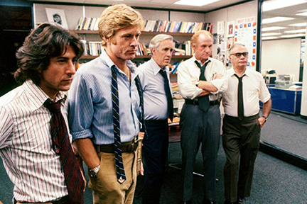 Five men in business attire in an office.