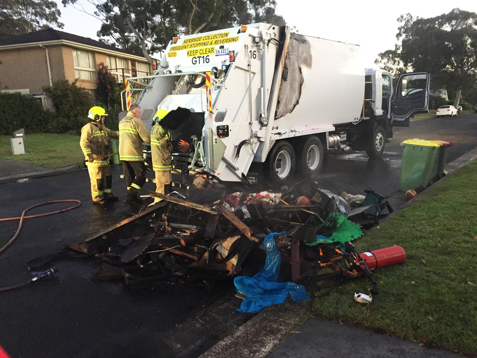 Image of firefighters trying to put out a fire in a large Council garbage truck fire in Sutherland Shire