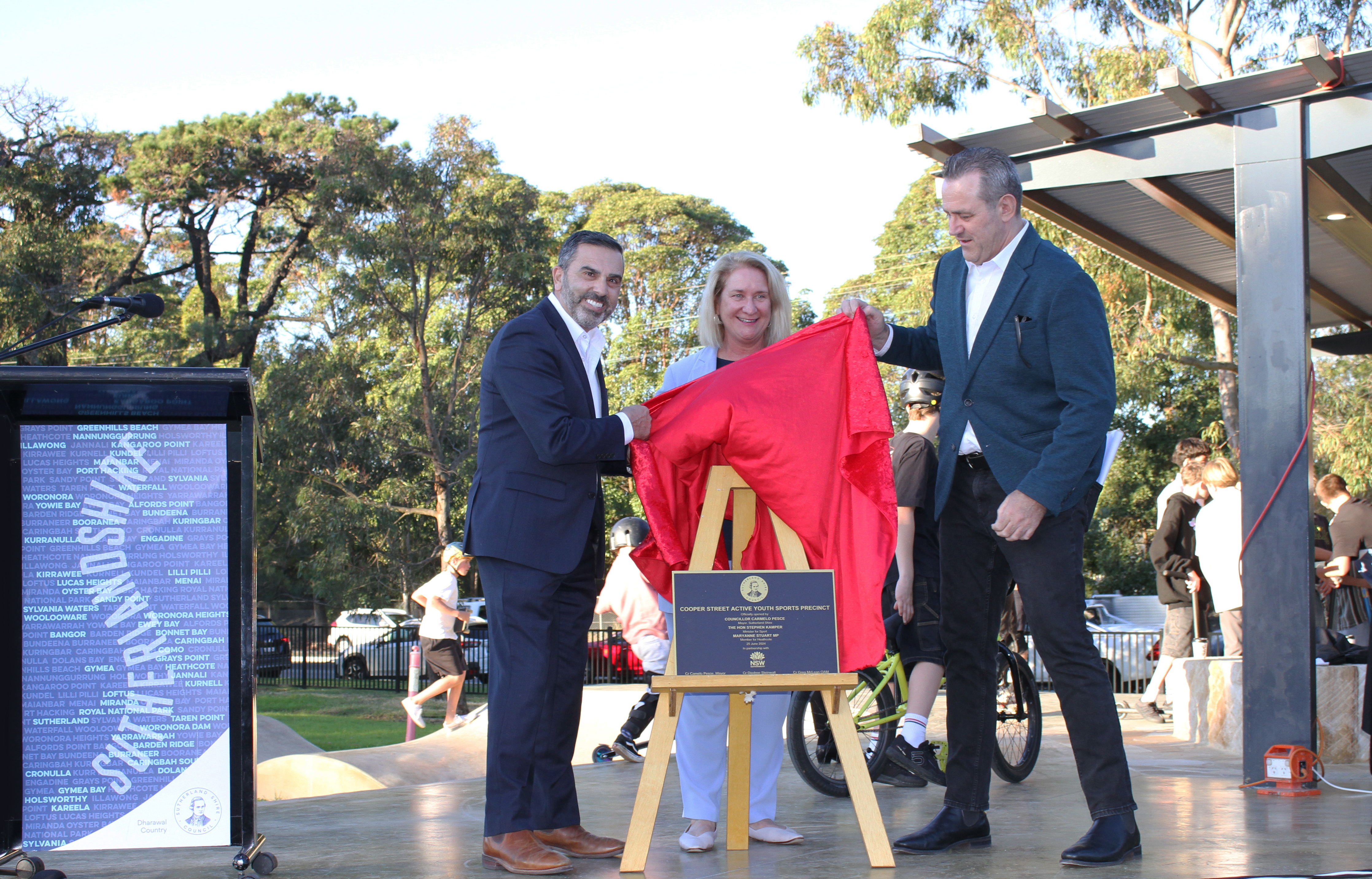 Sutherland Shire Mayor Councillor Carmelo Pesce, Member for Heathcote Maryanne Stuart, and Minister for Sport Steve Kamper revealing the plaque at the Cooper Street Active Youth Sports Precinct official opening