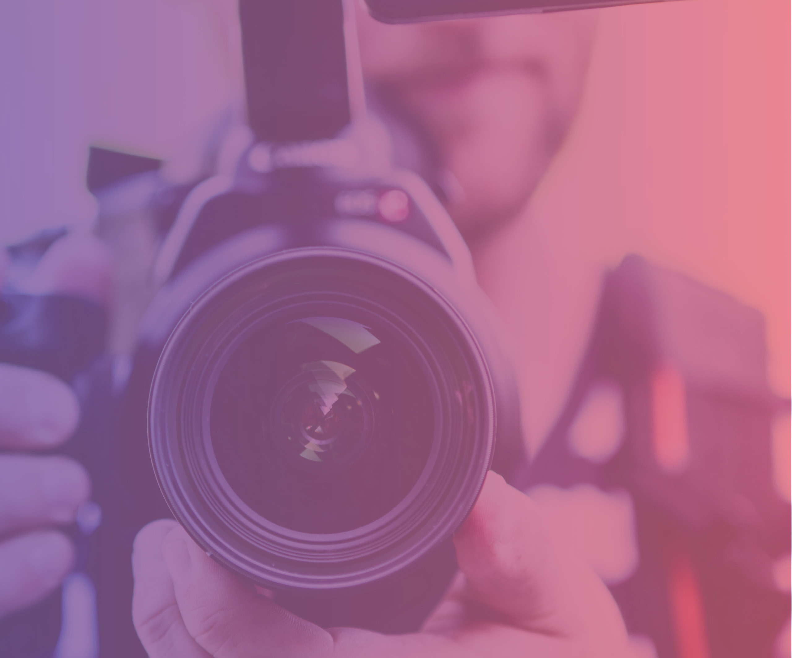 person holding camera with pink gradient