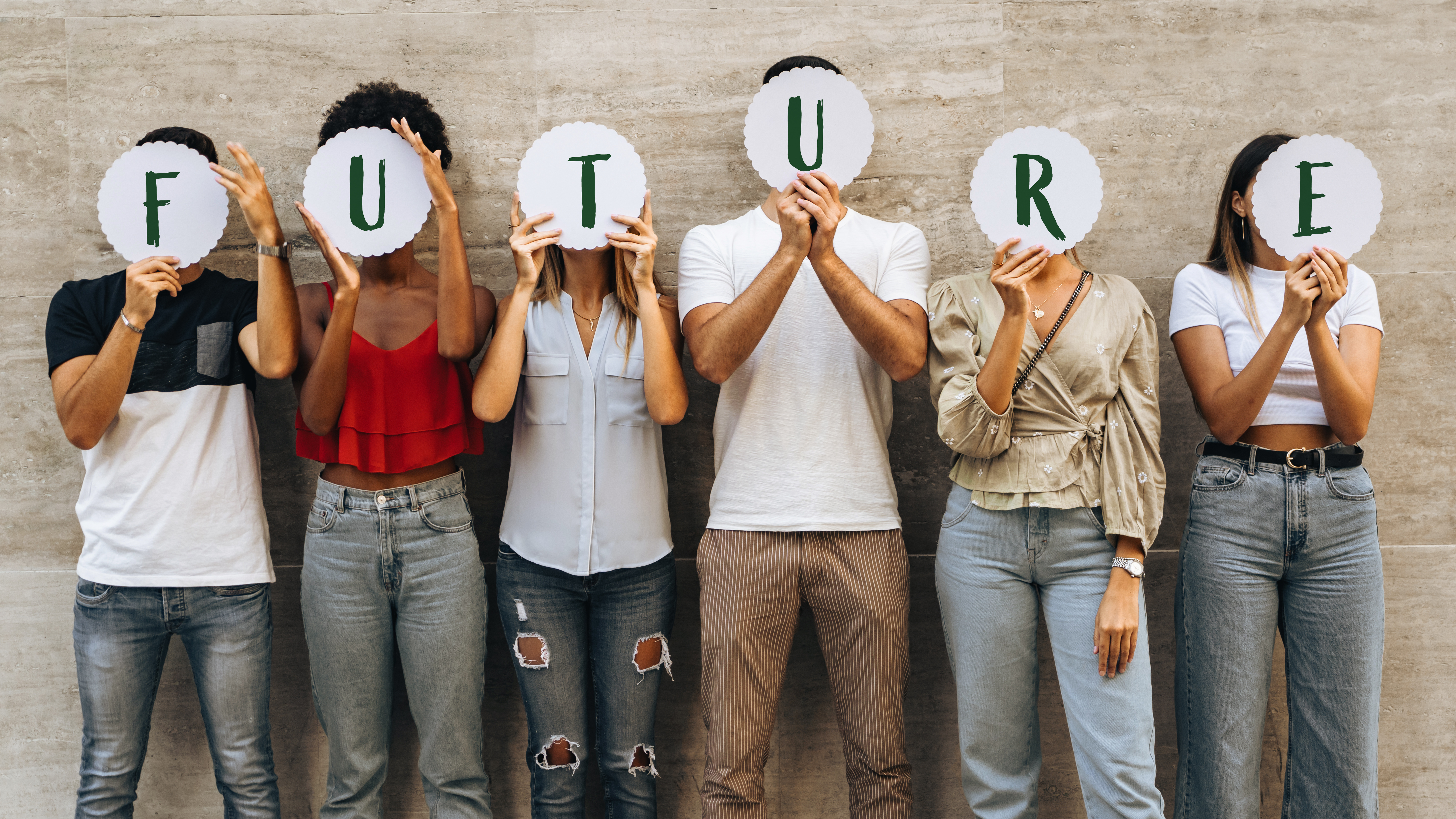 Young people hiding faces behind the word 'Future'