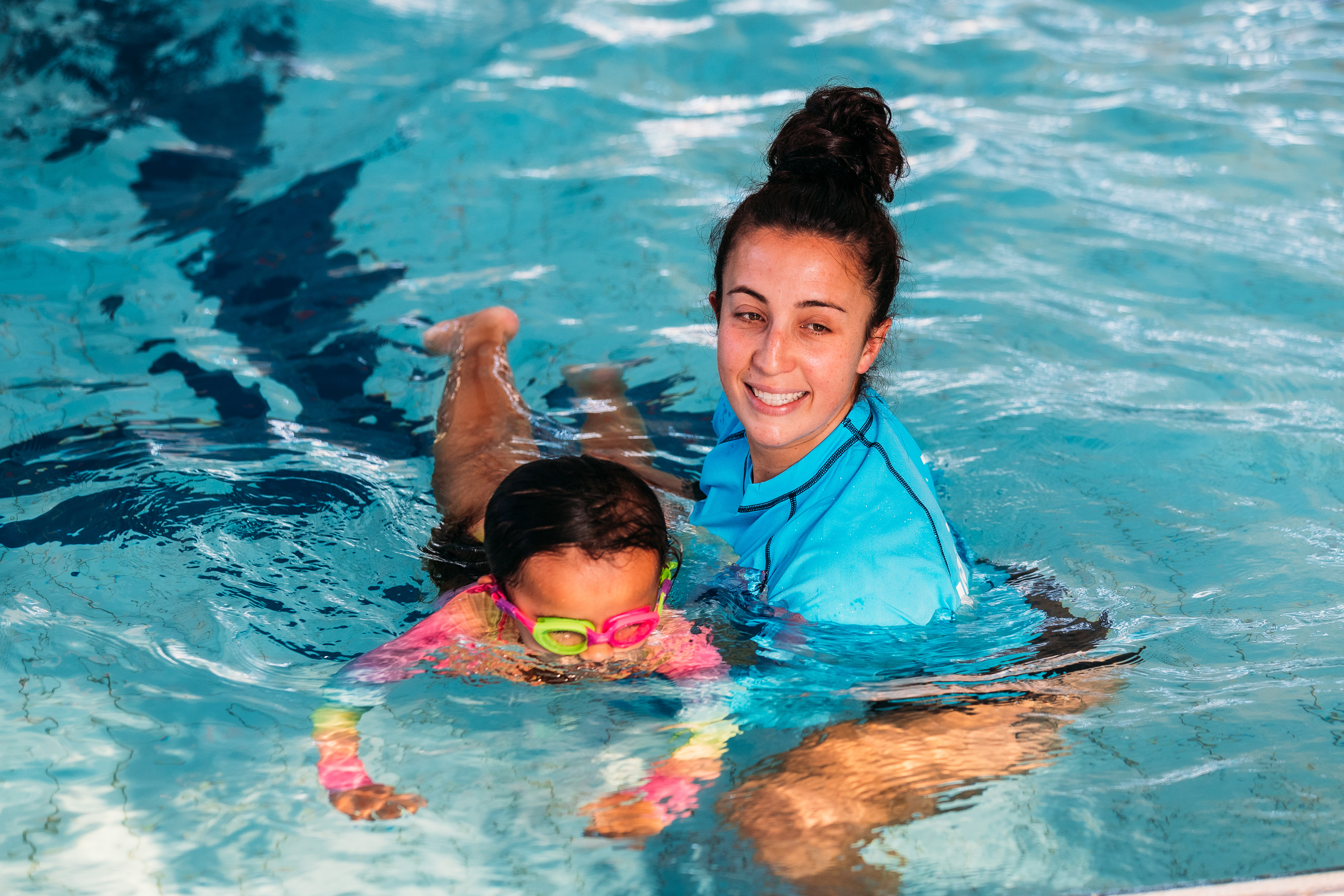 Swimming lessons instructor and child.