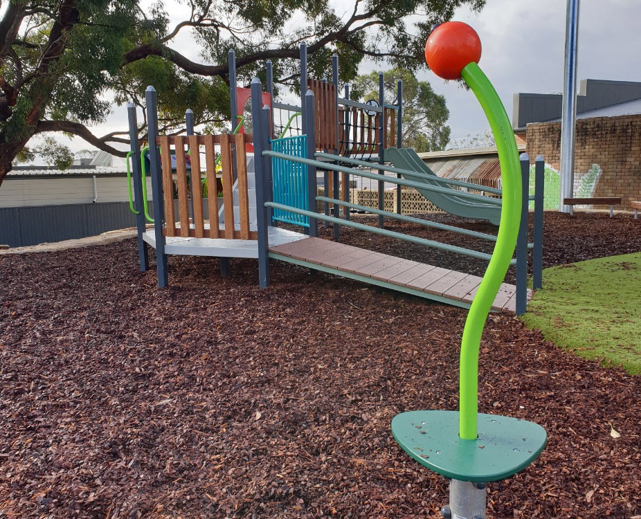 curved twister pole in front of ramp to multiply play equipment