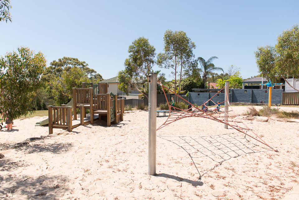 Climbing tower and net in playground with sand softfall