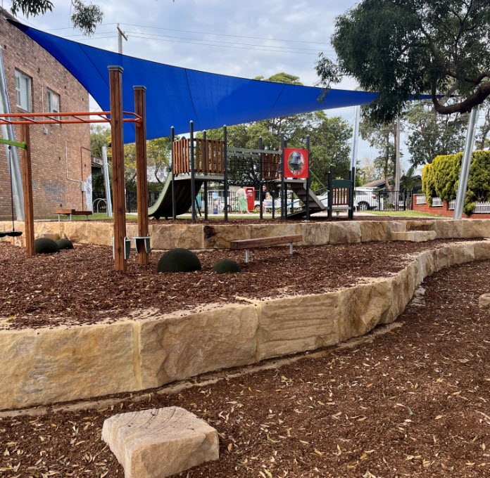 New synthetic turf and play equipment under blur shade sail