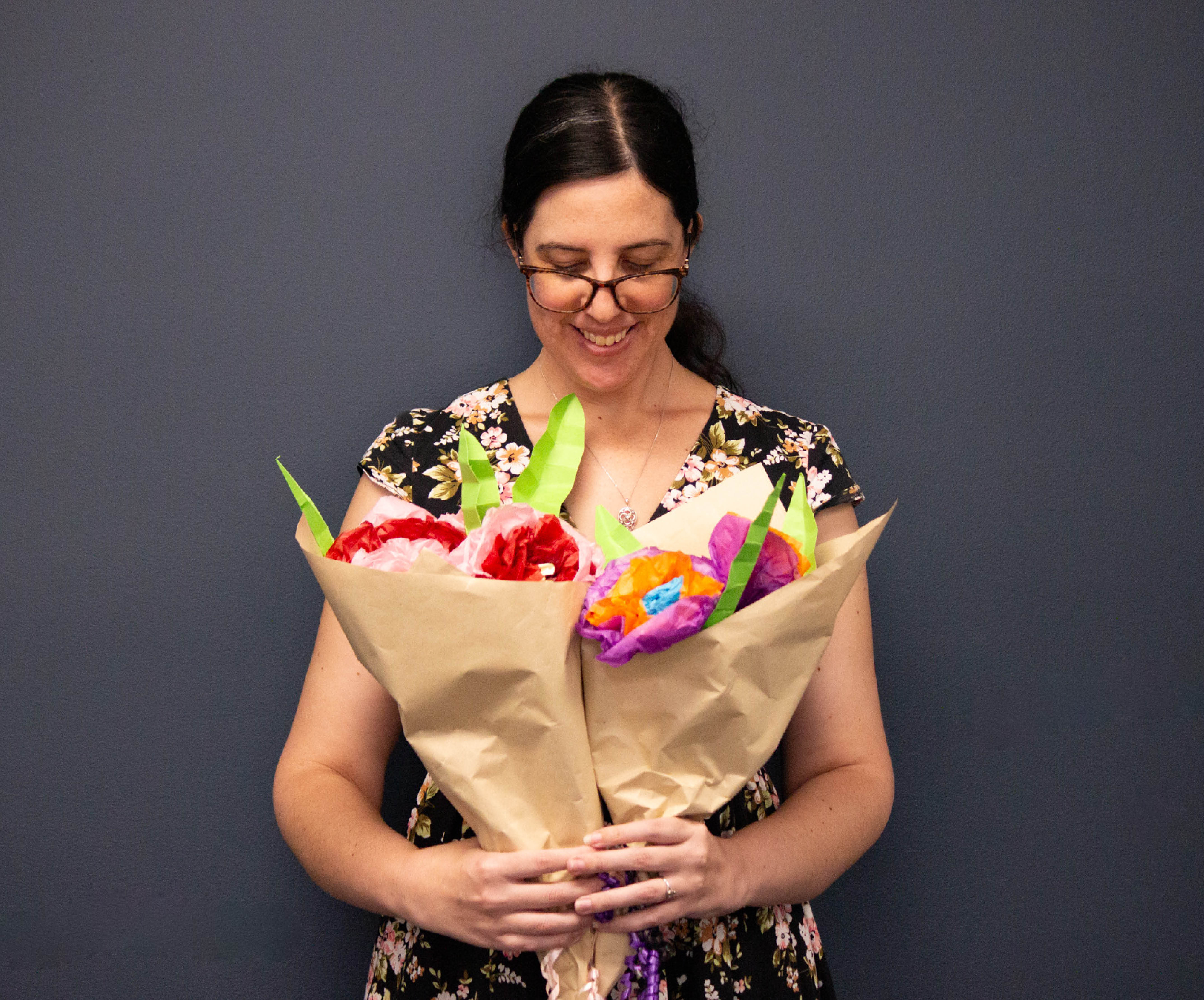 woman holding paper flower bouquets