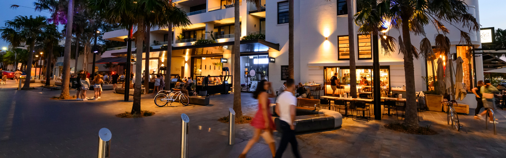 People walking in Cronulla Plaza at dusk